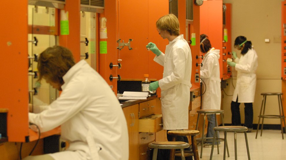 Row of students in a lab with orange lockers.