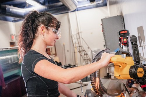 student_in_lab_operating_a_table_saw