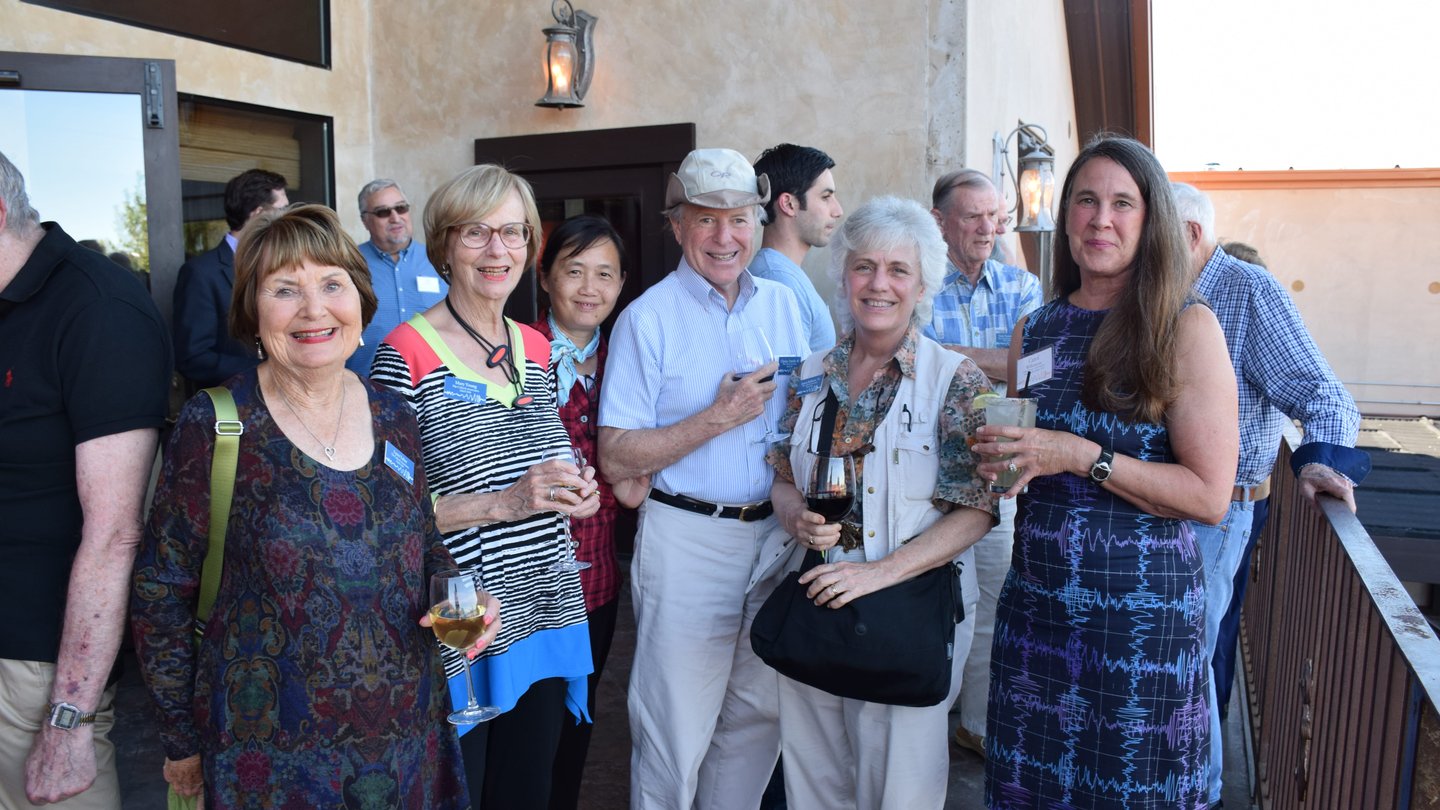 Group of people standing outside a balcony