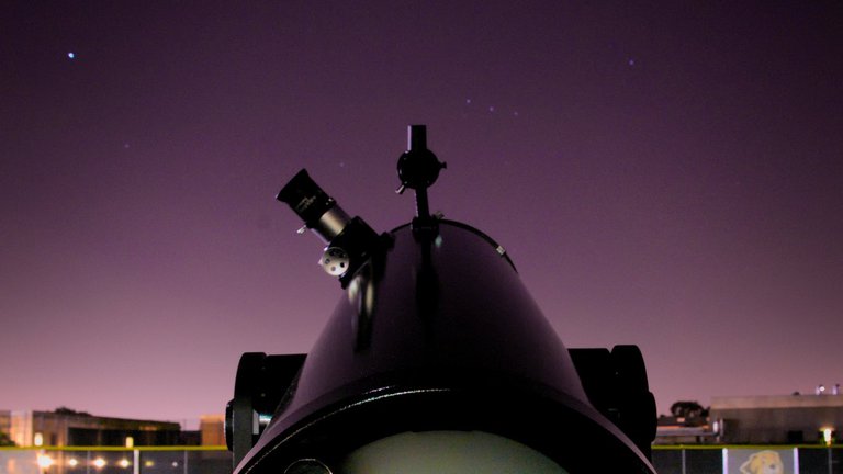 A telescope set up on the athletic fields in preparation for a night of stargazing after the lecture.