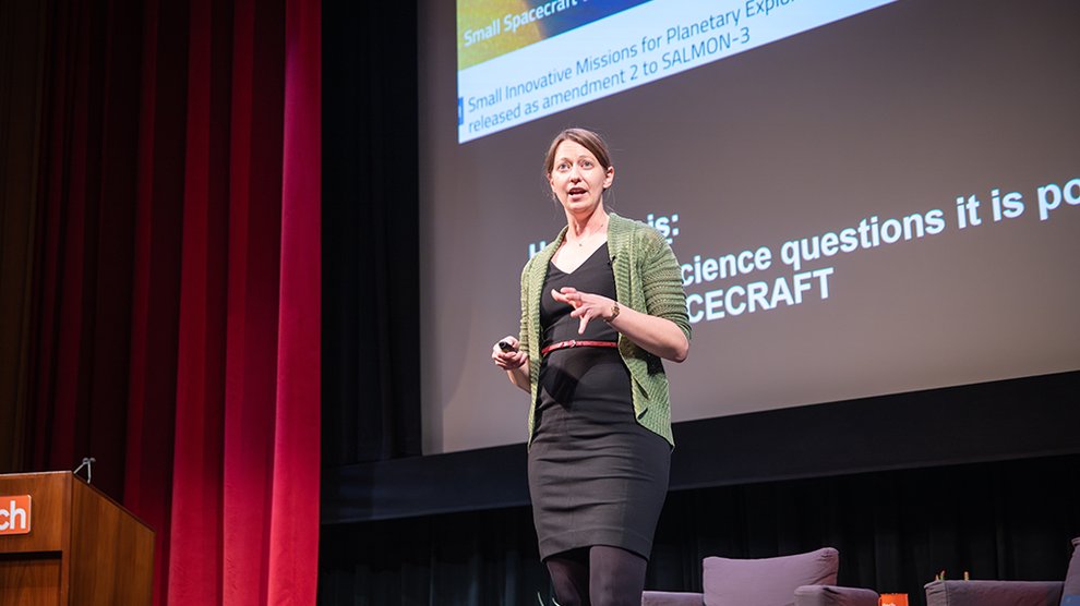 image of bethany ehlmann on stage talking to audience
