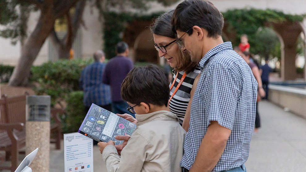 Family looking at book