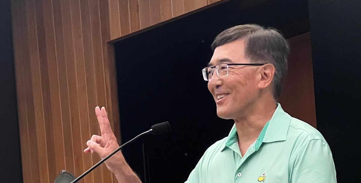 Alan Marumoto at a podium