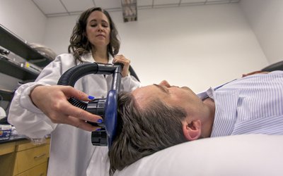 Woman scanning man's brain waves