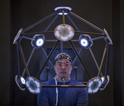 man sitting in brain scanning machine