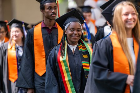 Caltech graduates enter for their commencement ceremony wearing caps and gowns.
