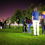 Visitors look through telescopes during a Caltech astronomy outreach event on the grass outside Cahill.