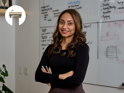 Image of Smruthi Karthikeyan in dark long-sleeve shirt in front of white board