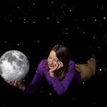 Bethany Ehlmann holding a model of the Moon in her hand