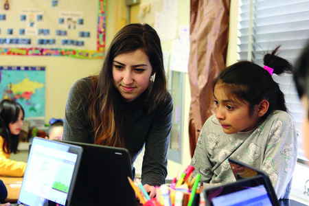 A Caltech computer science student helps a Pasadena third grader learn to code.