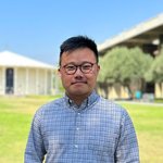 Peiwei Chen stands before the Beckman Auditorium on the Caltech campus.