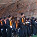 Orange, black, and white confetti falls on Caltech's newest graduates who are wearing their caps and gowns