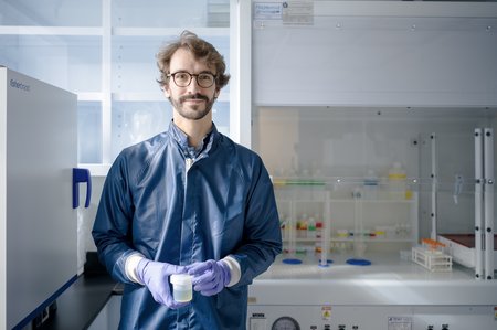 Image of Francois Tissot in lab wearing a lab coat