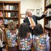 Caltech President Thomas Rosenbaum shows six visiting Girl Scout Brownies a basketball signed by eight Nobel laureates