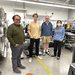 Team members standing in the lab.