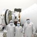 The team in front of spacecraft.