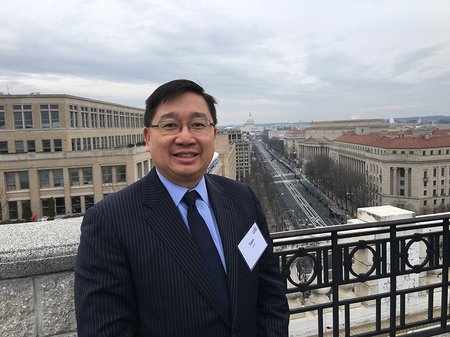 Photo of Caltech Alumnus Thomas Luke with Washington, D.C. in the background.