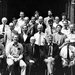 A group of about 30 men, many in jackets and ties, pose for a black and white photo of the physics faculty at the University of Chicago.
