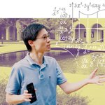 Man in glasses wearing a blue polo shirt, surrounded by equations