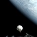 Cone-shaped SPHEREx in space in front of Earth.