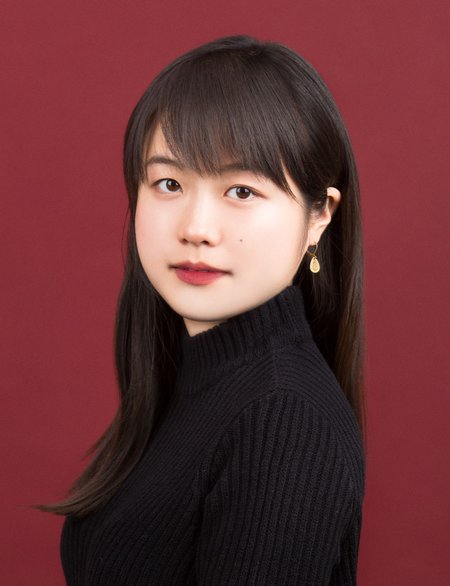 Portrait of Seo-young Silvia Kim in a black turtleneck on a red background