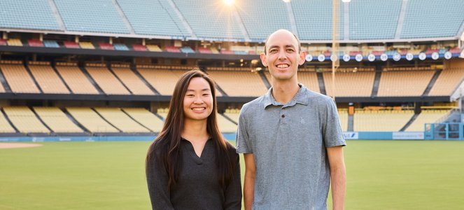Grace Peng and Ryan Casey stand on the field at Dodger Stadium