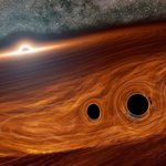 Artist's concept of a supermassive black hole, with a binary pair of black holes in its disk.